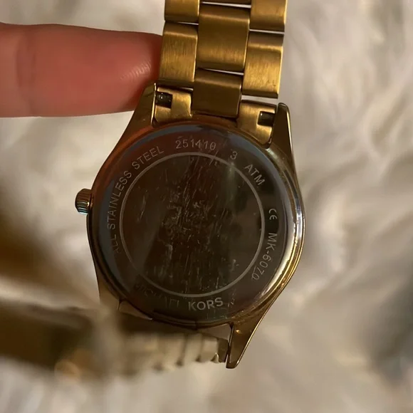 Michael Kors Women's gold watch with date and day